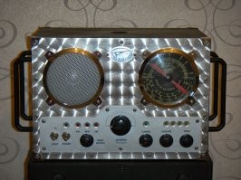 Это современная китайская реплика радиоприёмника, установленного на борту самолёта  Чарльза Линдберга "Spirit of St.Louis", на котором он совершил беспосадочный перелёт из Нью-Йорка в Париж в 1927 году. Точная копия, выпущенная в память Чарльза Линдберга. 

Насчет точной копии китайцы загнули, конечно - светодиоды на передней панели, блестящий полимерный пылезащитный колпачок на динамике в 20-х годах не применялись, их попросту не существовало. Да и шильдик такой вряд ли был. Но в целом неплохо.