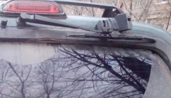 Хм... Я пачку из под сигарет так подкладывал, если "погода шептала". 
А на "дворнике" заднего стекла, вообще, специальное парковочное место, с завода, предусмотрено.