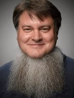 У мужика грудь волосатая, а т.к. сидит в свитере, то волосы повылезали через воротник