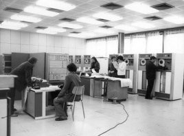 И периферии к самой машине еще несколько шкафов.  Устройства чтения с магнитной ленты, стол для набивки перфокарт,  АЦПУ  и т.д.