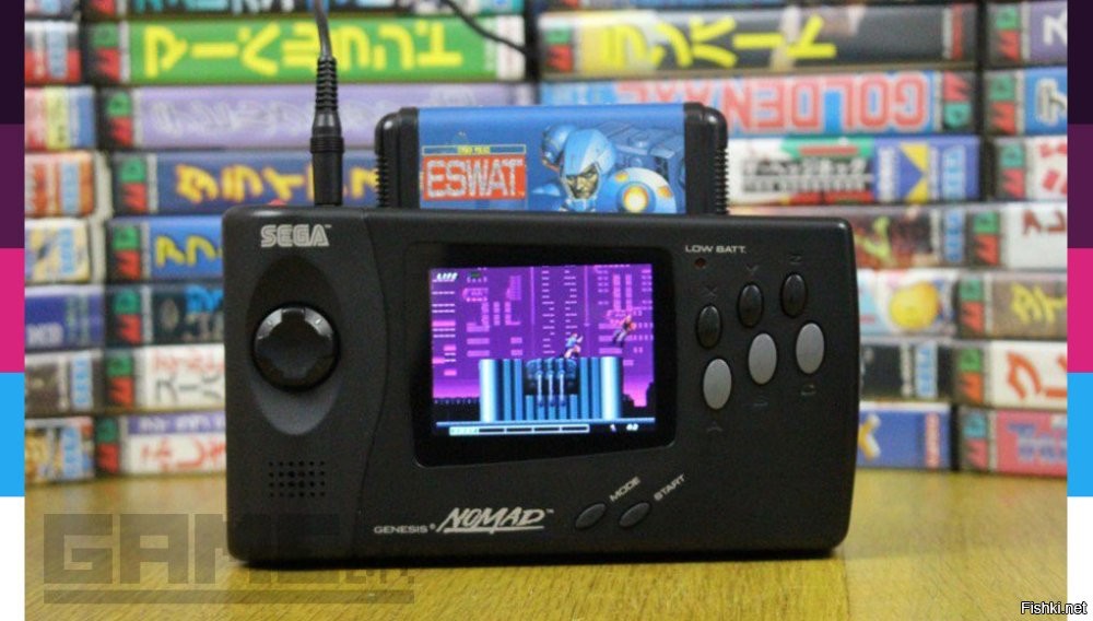SEGA NOMAD - портативная версия приставки Mega Drive, работающая на картриджах от стационарной. Там был цветной дисплей (что было ОЧЕНЬ круто для тех времён), и можно было играть во ВСЕ игры стационарной приставки Mega Drive / Genesis. Единственный реальный конкурент - Nintendo Game Boy - на момент актуальности отставал от Nomad.

Этот гаджет был поистине легендарным, в продаже я у нас ни разу не видел, у знакомых тоже ни у кого не было. Но мы знали, что такой гаджет существует (хотя, не все в это верили). И только спустя годы я уже в интернете прочитал про эту приставку, что она реально выпускалась в то время. 

А в середине 90-х - любой подросток в России продал бы душу дьяволу за такую вещь!