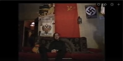 У чувака реально в голове насрано было, по крайней мере в начале 90-х. Вешать на стене символы противоположной идеологии. В видео с 2:00 минуты он пытается объяснить эту херню, но это ещё больше подчёркивает его шизофрению.