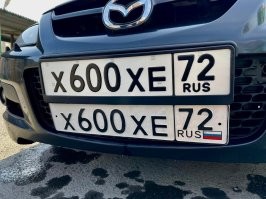 ничего он там не заклеивал, это номера старого образца и их можно было вешать. На автомобили со свежей регистрацией теперь такие вешать нельзя, если на автомобиле регистрация старая то можно повесить номера и старого образца. Для сравнения вот вам рядом два варианта номера(фото)