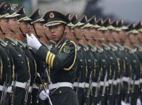 An officer of a Chinese PLA honour guard uses a string to ensure members of the honour guard are standing in a straight line, before a welcoming ceremony for Germany's Chancellor Merkel outside the Great Hall of the People in Beijing. KIM KYUNG-HOON/REUTERS