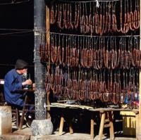 Не фотошоп, но и не бекон. Большинство китайских семей с наступлением зимы делают домашние колбаски "Сян чан". Хорошо очищенные свиные кишки забивают фаршем и на всю зиму вывешивают на балкон или просто на улицу для "созревания". В сыром виде не употребляется - перед употреблением колбаски приготавливаются в пароварке.